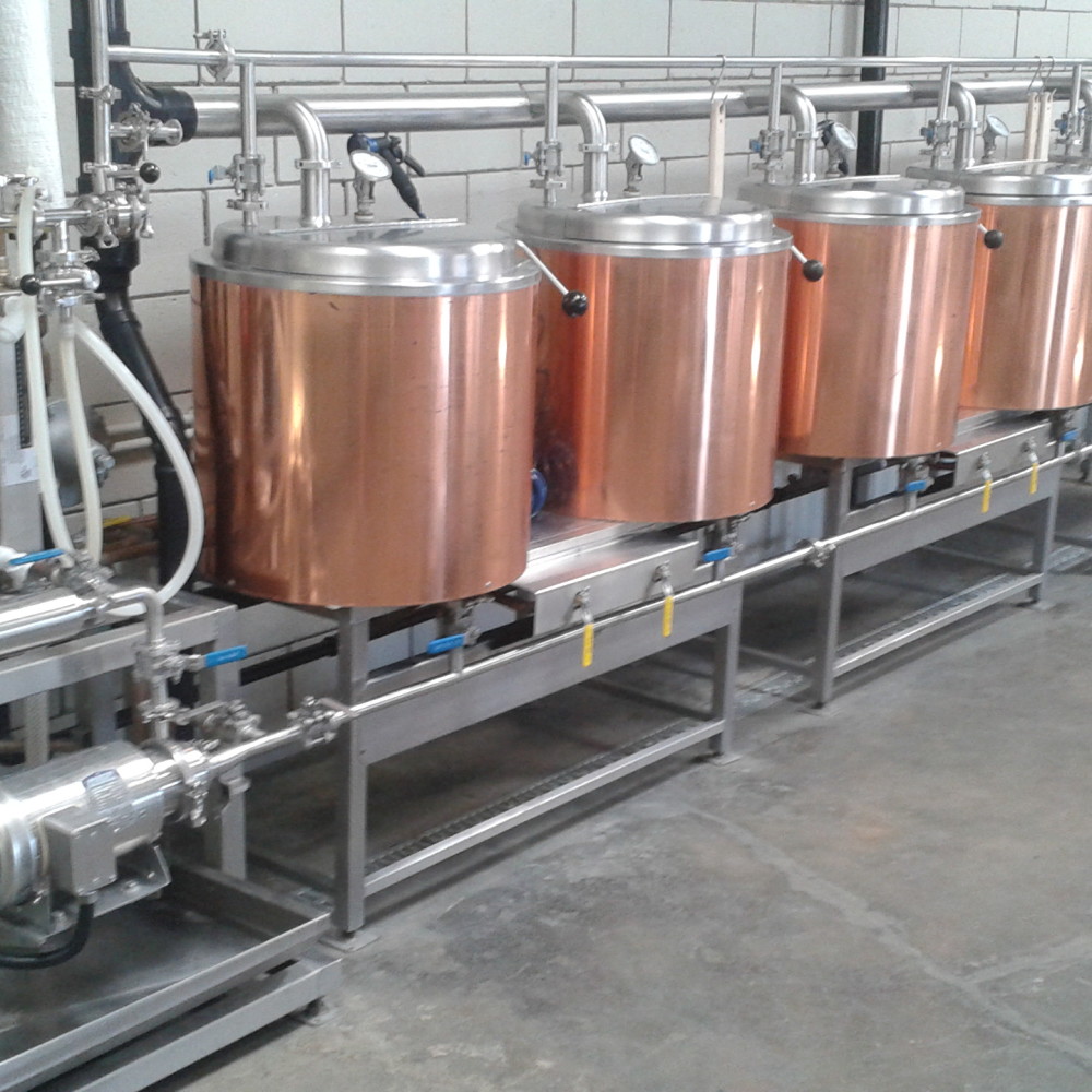Image is of the row of brass kettles next to the transfer equipment to the left