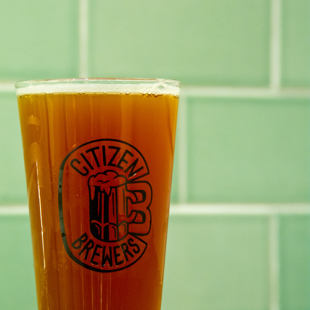 Image is a close up of a filled beer glass
